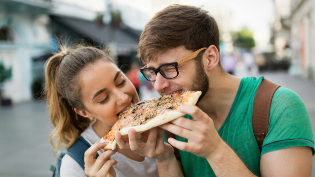 happy-group-of-friends-eating-pizza-outdoors-VwaLJGSG5hQ