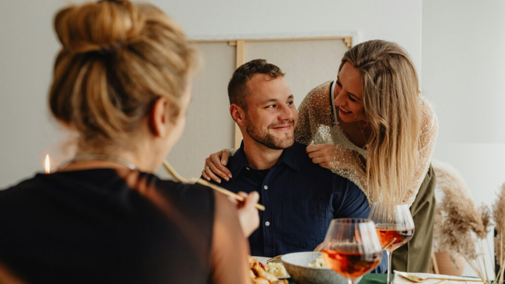 man-and-a-woman-sitting-at-a-table-with-food-OBAcAHlbyxI