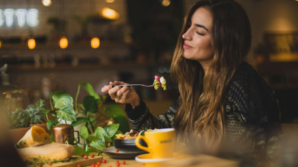 woman-holding-fork-in-front-table-Orz90t6o0e4