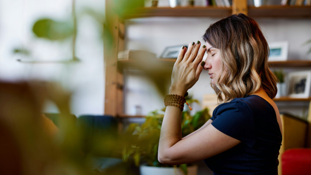 yogi-woman-sitting-at-home-and-praying-while-sitting-on-the-floor-w6R316CsbEo
